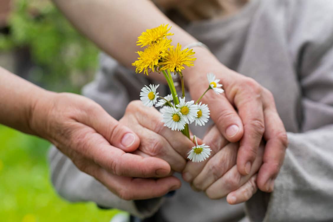 Hands holding flowers scaled 1 1128x752 - Dementia and Alzheimer’s: Updates from a Leading Geriatrician